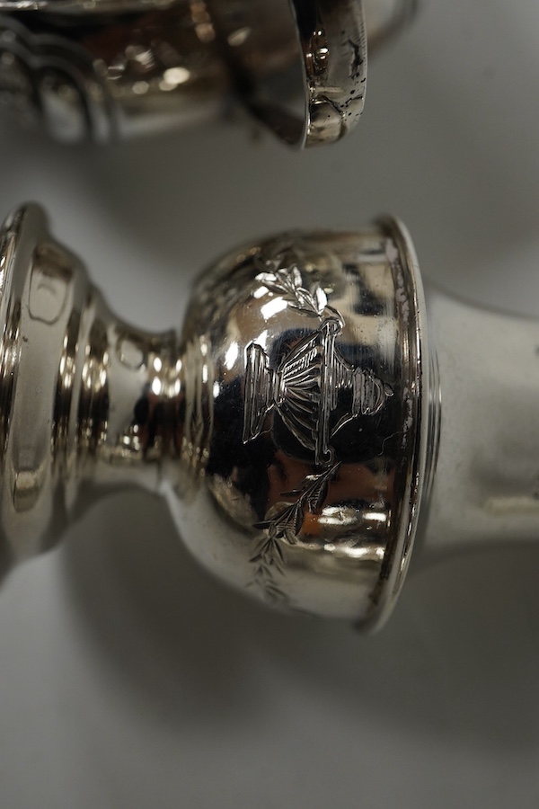 A set of four late Victorian embossed silver two handled salts, Birmingham, 1896, 98mm and a pair of silver peppers. Condition - fair to good